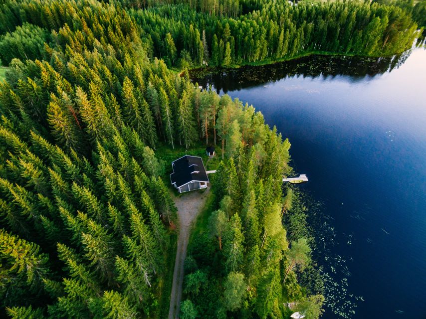 From Rovaniemi: Midnight Sun Forest Lake Float - Hot Drinks, Gingerbread, and Guide Stories on the Shore