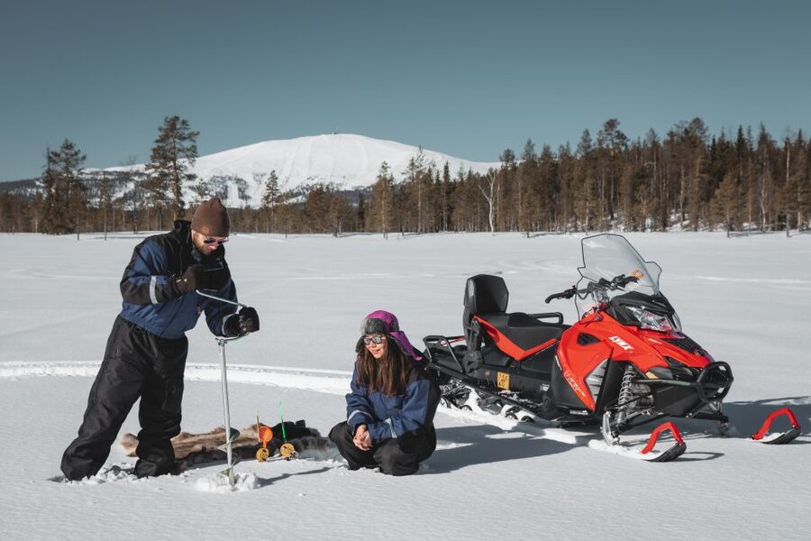 Levi: Snowmobile Safari with Ice Fishing and Outdoor Lunch - Ice fishing on a frozen lake, the real arctic skill part