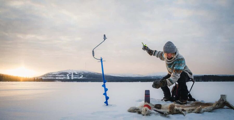 Pyhä: Ice Fishing Experience at Frozen Lake - Drilling the hole: the moment ice fishing becomes real