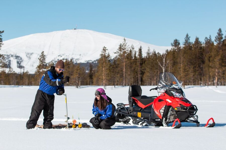 Ylläs: Snowmobile Adventure with Ice Fishing - Ice fishing on a frozen lake: learning the approach, then trying your luck